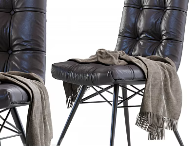 Black Leather Lounge Chair With Tufted Design And Gray Blanket On Metal Legs 3d model