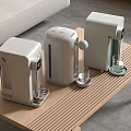 Three Modern Kitchen Appliances On Wooden Table With Glass Cups