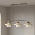 Three Light Modern Chandelier With Cream Shades Red Bases And Metal Frame In Light Colored Interior