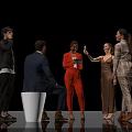 Group of People Socializing in Stylish Outfits With White Stool and Phone Interaction