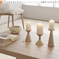 Minimalist White Candle Holders On Wooden Table With Open Book And Ceramic Bowl