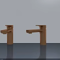 Two Copper Bathroom Faucets On Gray Countertop With Light Wall Background