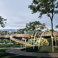 Yellow Sculpture Structure In Outdoor Park With Trees Grass And Slide