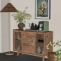 Wooden Sideboard with Glass Doors and Dinnerware Inside Potted Plant Floor Lamp and Wall Art
