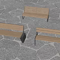 Wooden Outdoor Benches With Metal Frames On Stone Pavement And Grass