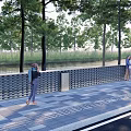 Brick Fence Along Riverside Paved Sidewalk Near Road With Trees And People Walking