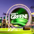 Green Themed Stage With Stay Green Sign And Plant Decorations At Night