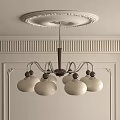 Elegant Chandelier With White Glass Shades Metal Frame And Ceiling Medallion In Decorative Interior