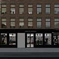 James & Company Storefront Facade Of Brick Building With Large Windows And Mannequin Displays
