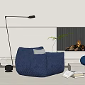 Comfortable Blue Single Sofa with Quilted Design and Fireplace Floor Lamp Green Plant Books