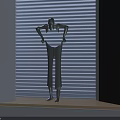 Decorative Ornament Set Featuring Human Shaped Metallic Figurine On Wooden Window Sill With Window Blinds