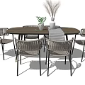 Round Wooden Dining Table Set with Rattan Chairs Metal Frames and Dried Flower Decor