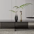 Modern Black Coffee Table with Decorative Items Vase Sculpture and Green Plant on Minimalist Rug