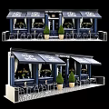 The Manhattan Cafe Exterior Featuring Blue Facade Black Awnings Outdoor Tables Chairs Green Potted Plants