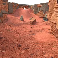Red Sandstone Canyon Landscape With Rock Formations Sandy Ground And Natural Arch