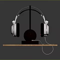 White And Black Headphones On Black Stand With Wooden Platform And Cable