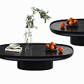 Modern Black Round Coffee Table With Green Plant Vase Oranges Book And Plate