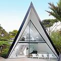 Unique Triangular Guesthouse Architecture With Sharp Metal Roof And Warm Lighting Surrounded By Trees