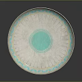 Circular Carved Sculpture Plate with Blue Geometric Patterns and Central Blue Circle on White Surface