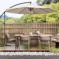 Outdoor Patio Table with Wicker Chairs Large Umbrella Wooden Deck Bamboo Fence and Green Plants