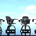 Black Kids Desk and Chair with Wheels Against Blue Sky White Clouds and Water Reflection