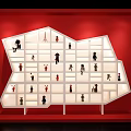 White Display Cabinet with Irregular Shelves Showcasing Small Figurines Against Red Background and Lit Compartments