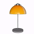 Golden Modern Table Lamp With Dome Shade And Round Metal Base On Light Wall