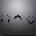 Three Stylish Electronic Headphones With Black And Blue Design On Reflective Surface