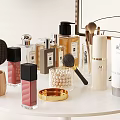Perfumes And Cosmetics Display With Various Perfume Bottles Lipsticks Makeup Brushes And Moisturizer On White Table