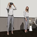 Women Using VR Headset in Modern Space Standing and Sitting with Trophy Table