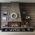 Cozy Wooden Fireplace Interior with Wreath Burning Fire Framed Pictures Small Plants and Firewood Stack