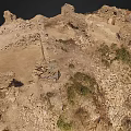 Ancient Historical Ruins Featuring Stone Walls Dirt Ground And Scattered Vegetation