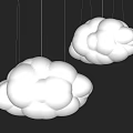 Two White Cloud Shaped Chandeliers Hanging On Dark Colored Wall