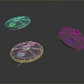 Three Circular Metallic Components With Holes And Raised Parts On Dark Background