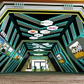 Modern Entrance Hall Interior With Green Wave Wall Yellow Wooden Ceiling Brown Carpet And Logo