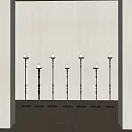 Six Black Candle Lamps Arranged Along Wall With Wooden Floor And Light Colored Walls