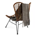 Wicker Lounge Chair With Plaid Pillow And Linen Blanket On Black Metal Frame