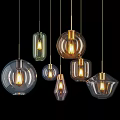 Modern Glass Pendant Lights In Various Shapes With Golden Metal Frames And Illuminated Bulbs