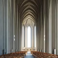 Wooden Chairs In Religious Gathering Place With White Walls Curtains And Natural Light