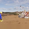 Man in blue outfit with yellow helmet kneeling near exploding device and flying debris