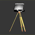 Black Electronic Device Mounted On Yellow Tripod Stand For Portable Use