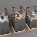 Various Antique Artifacts In Glass Display Cases With Gray Pedestals And Soft Lighting