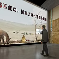 Exhibition Hall Featuring National Land Protection With Horse Model Sand Table And Visitor Observing