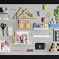 Pegboard Wall With Hanging Accessories Including Scissors Stationery Toys Cactus Decor And Mini Houses