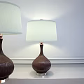 Brown Textured Table Lamp With Light Colored Lampshade On White Wall Background 3d model