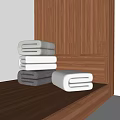Folded Towels In Gray White And Light Gray On Wooden Cabinet And Floor