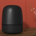 Black Wireless Speaker on Wooden Table with Orange Wall and Black Vase with Pink Flowers