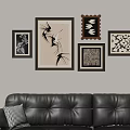 Decorative Photo Wall With Various Framed Artworks And Patterns Above Leather Sofa In Living Room