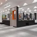 Modern Exhibition Hall Interior With Black Reception Desk Orange Accent Wall Artworks And Linear Pendant Lights