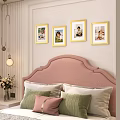 Photo Wall With Framed Photos Above Pink Headboard In Cozy Bedroom